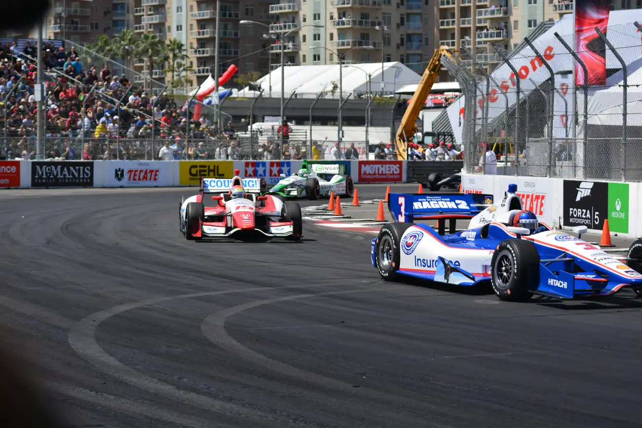 Race cars turning through a street course