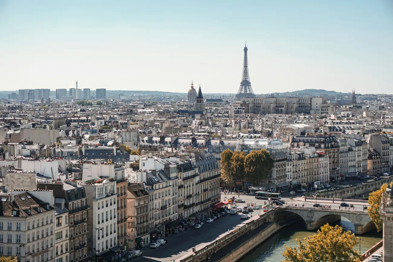 Paris skyline from above with rooftops and the Eiffel Tower in the distance