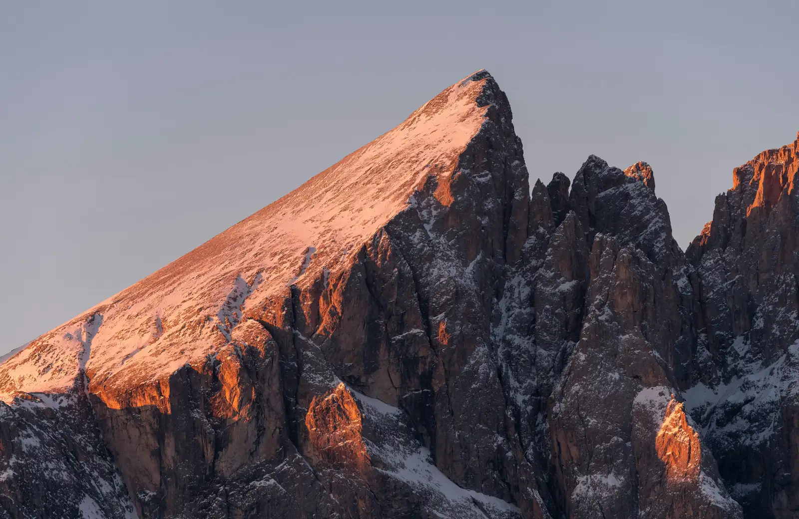 A steep mountain face at sunrise
