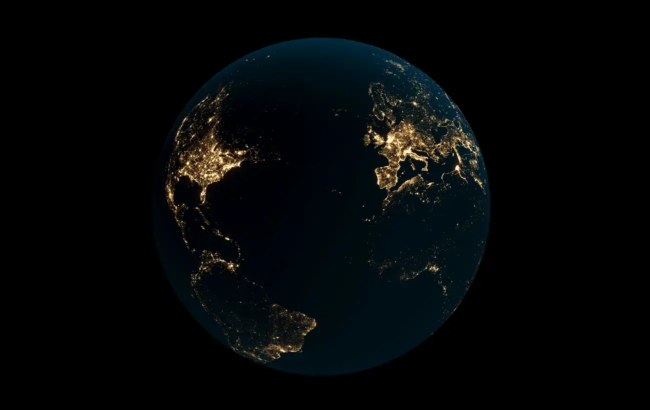 Earth at night with city lights across North America and Europe