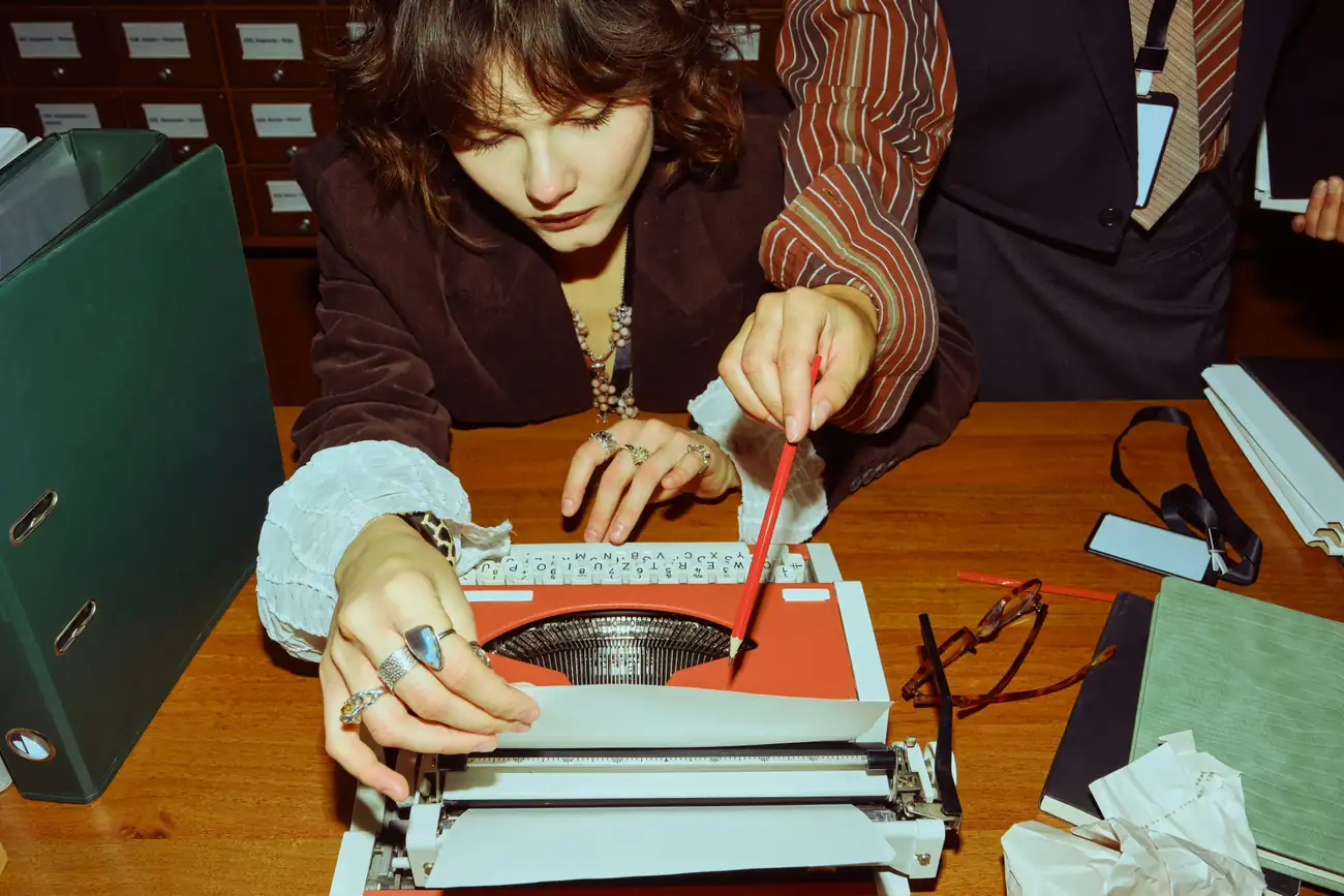 A person marking a route on a typewriter page